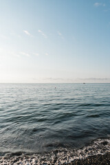Obraz premium Beautiful white clouds on blue sky over calm sea ocean with sunlight reflection