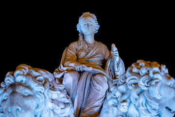 Statue of the goddess Cibeles with the two lions and Christmas lighting during a dark winter night in the emblematic Plaza de Cibeles in the city of Madrid, Spain