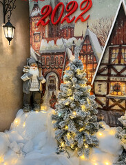 Santa Claus is standing at the Christmas tree under the lantern. Christmas Santa Claus. Christmas mood