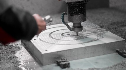 CNC operator blows the shavings from the aluminum mold. Numerical Control in Heavy Industry
