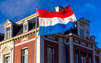 Netherlands. State national flag against a blue sky .