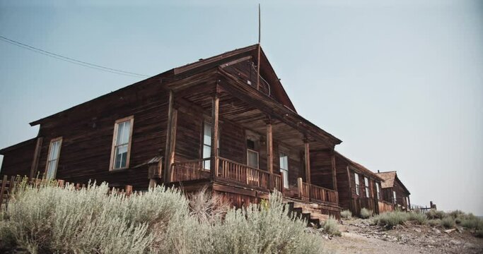 Creepy old abandoned building with birds flying all around in a western ghost town in the gold rush mining area of California