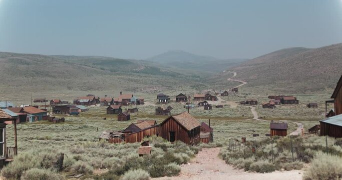 Slow motion pan of Bodie, California, a preserved ghost town in the hills of CA