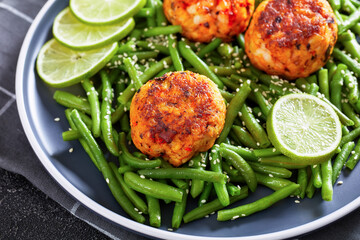 Prawn and Crab Cakes on a plate with green beans