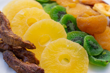 Various candied fruits, sun-dried bananas on the table close-up. Healthy sweets.