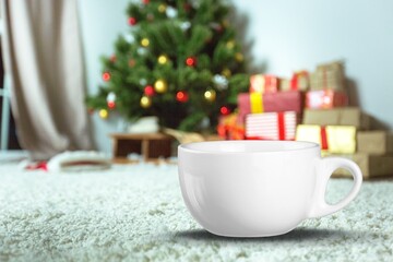 Obraz na płótnie Canvas White ceramic tea mug with christmas decoration on the background