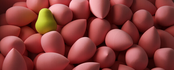 beauty background a bunch of pink gentle sponges and one contrast green conflict for makeup banner dark key