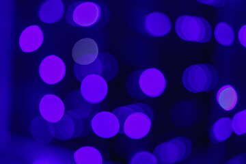 Christmas festive background of blue magenta bokeh.