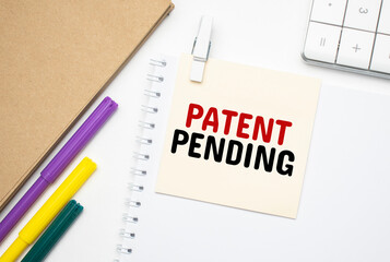 Patent Pending Notebook on laptop keyboard, on light background