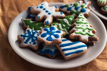 Glazed homemade gingerbread cookies. A plate with christmas sweets