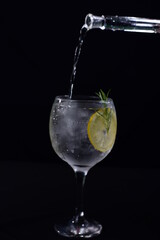 citrus fruit drink and ice isolated on black background
