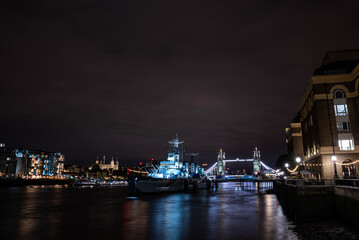 Fototapeta na wymiar Iconic Tower Bridge view connecting London with Southwark over Thames River, UK. Beautiful view of the illuminated bridge at night.