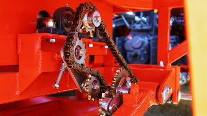 Chains and gears of machines. Chain drive to transmit power of farm machinery. Closeup and focus on the subject.