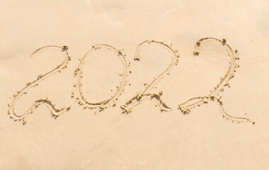 inscription 2022 on a sandy beach