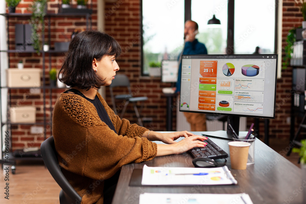 Poster entrepreneur looking at computer screen analyzing digital marketing graphs working at management str