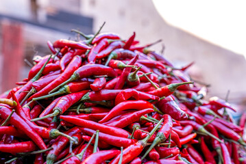 Close up of heap of spicy red chillies in abundance for sale at street marketplace