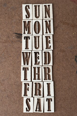 days of the workweek (sun to sat) in wooden stencil font on grungy work board - obrazy, fototapety, plakaty