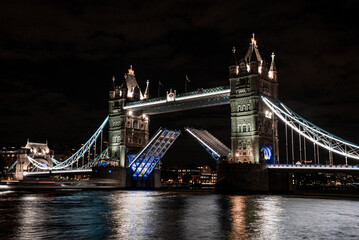 London Tower Bridge lifting up at night. Night lights illuminating famous London Tower bridge.