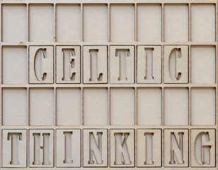 the phrase "celtic thinking" in wooden stencil font on paper