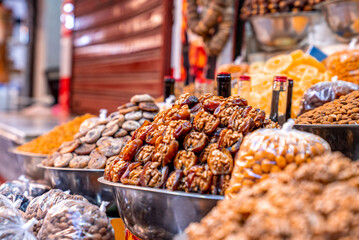 Dried apricots and figs and other dried fruits stuffed with walnuts in container for sale in the local market