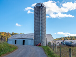Grain Silo that is near a gravel road.