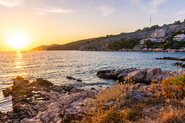 Beautiufl sunset on the rocky beach of Hvar Island, Croatia - obrazy, fototapety, plakaty