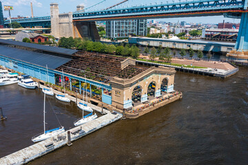 Naklejka premium Aerial view of a municipal pier, boats, and bridge in Philadelphia
