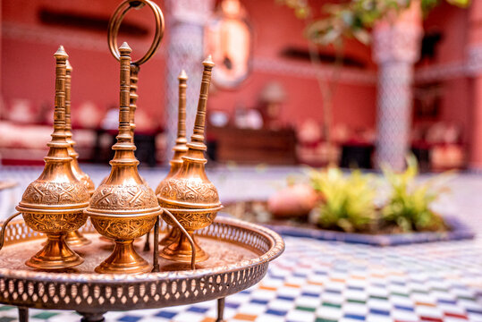 Close up of decorative ancient metal oil lamp with ring on table