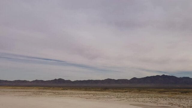Willcox Playa in Arizona is an ancient lake bed with silhouetted mountain, desert landscape aerial