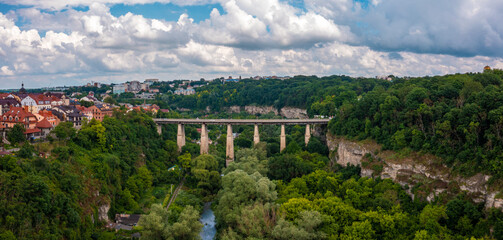 Aerial view of th ebeautiful bridge going over the green valley in Europe.