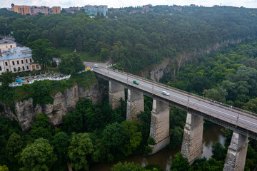 Aerial view of th ebeautiful bridge going over the green valley in Europe.