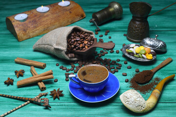 Turkish coffee concept. Copper pot (Cezve), vintage coffee grinder, coffee beans on a dark wooden background. Arab Turkish east coffee top view on dark wood background