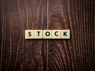 Stock word made of square letter word on wooden background