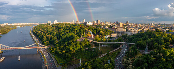 Panoramic view of Kyiv city with a beautiful rainbow over the city. Aerial view of the Arch of Friendship of Peoples.