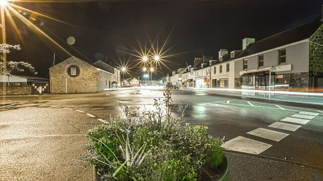 View of traffic movement in timelapse in the town of Guernsey Island in the English Channel off the coast of Normandy, part of the Bailiwick of Guernsey at night.