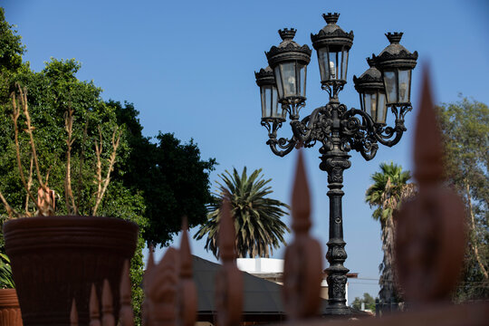Tecate, Baja California, Mexico - September 14, 2021: Late afternoon light shines on historic downtown street lights.