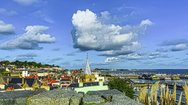 rooftops and the Town Church by the harbor at Saint Peter Port, in Guernsey, Channel Islands,UK. Cityscape, motion timelapse at daytime