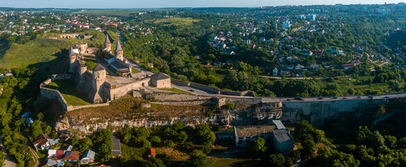 Aerial view of the romantic stone medievel castle on top of the mountain during sunny summer day.