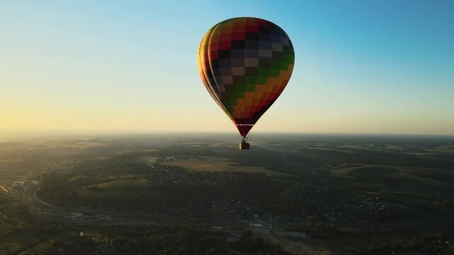 balloon flight over the city and river at sunset