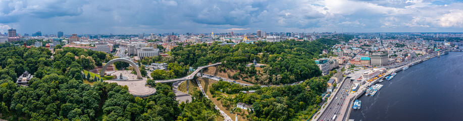 Panoramic view of Kyiv from the sky. Sunset over summer Kiev with Arch of Friendship of Peoples. Aerial view