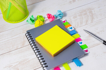 Top view of a gray notepad with colorful bookmarks and a blank yellow notepad. Business planning or...