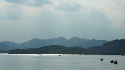 The beautiful lake landscapes in the Hangzhou city of the China in spring with the peaceful lake and fresh green mountains