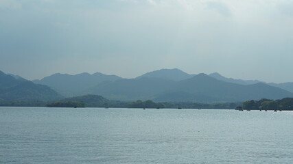 The beautiful lake landscapes in the Hangzhou city of the China in spring with the peaceful lake and fresh green mountains