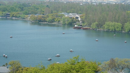 The beautiful lake landscapes in the Hangzhou city of the China in spring with the peaceful lake and fresh green mountains