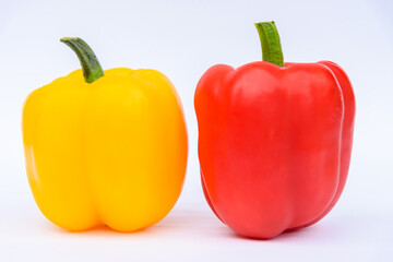red and yellow sweet peppers on white background