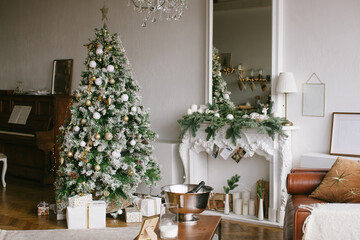 Christmas interior in retro style. White fireplace and mirror with christmas tree garland.