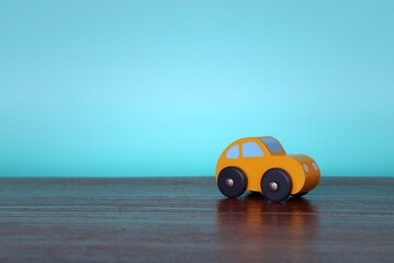Fototapeta na wymiar Close up image of wooden toy car with copy space for text. Blue background