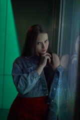 Portrait of a Young Woman at Night in Neon Light. High quality photo