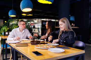 Young designers discuss new project ideas with their partners in the conference room at lunch. Business people are discussing a new business project in the office.