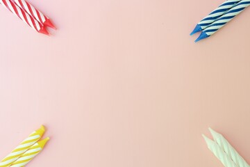 Colourful candles isolated in the green rope on pink background. Birthday,Christmas and special greetings concept. © Hari
